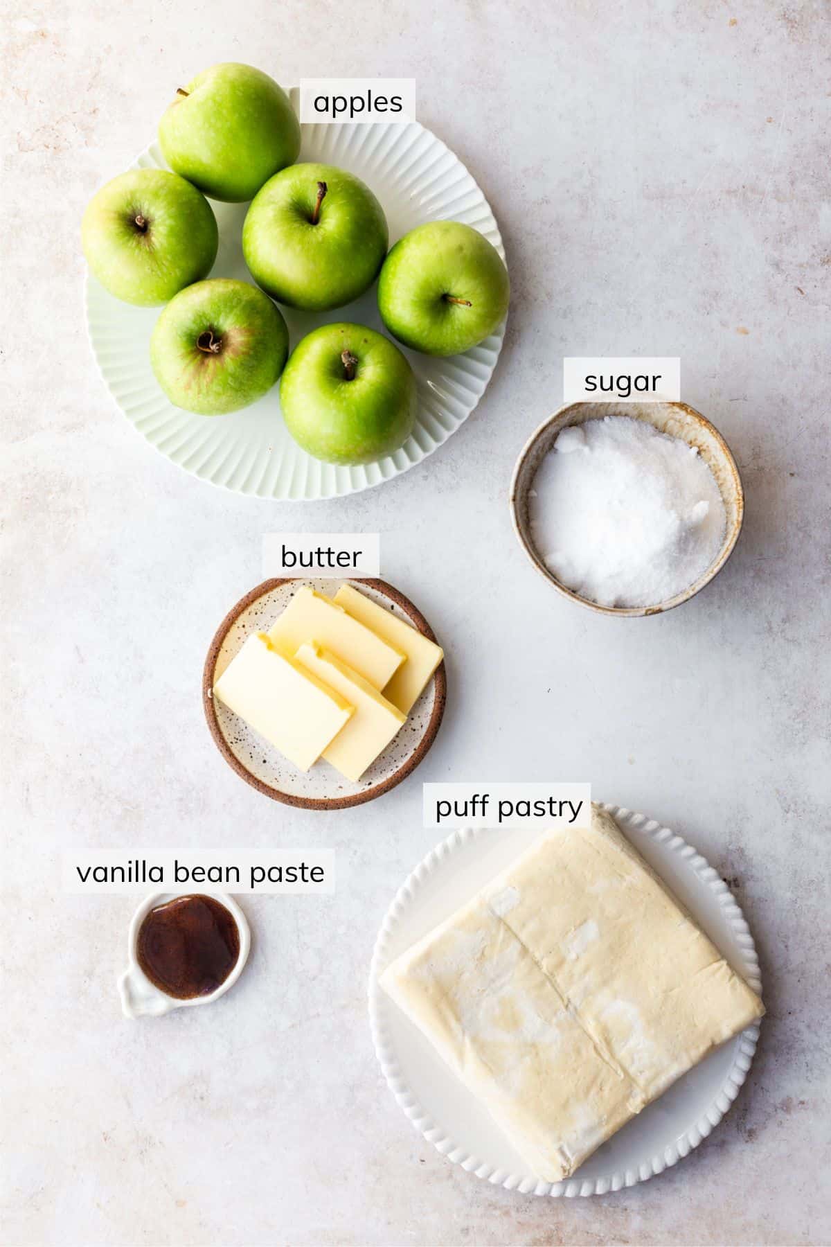 Individual ingredents needed to make Tarte Tatin Pommes on a countertop.