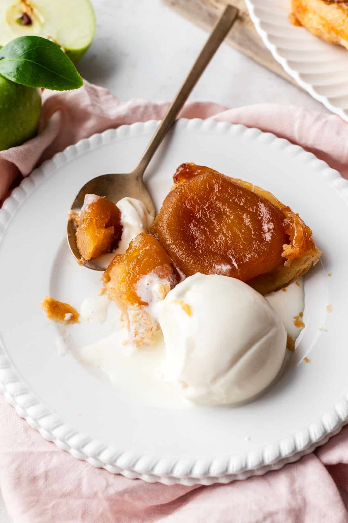Wedge of Tarte Tatin Pommes with scoop of ice cream.